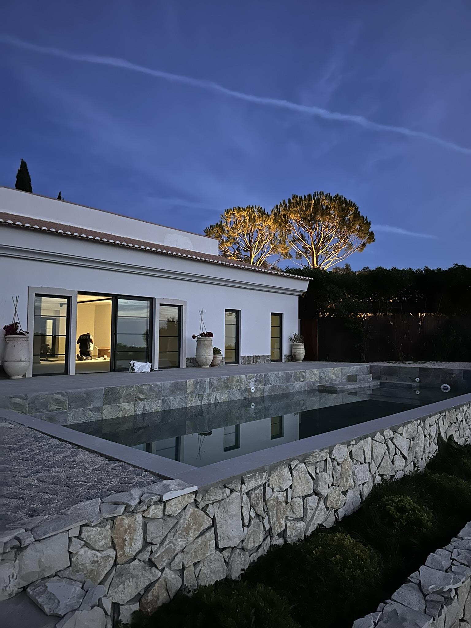 Subtle workshop photograph behind the contact card